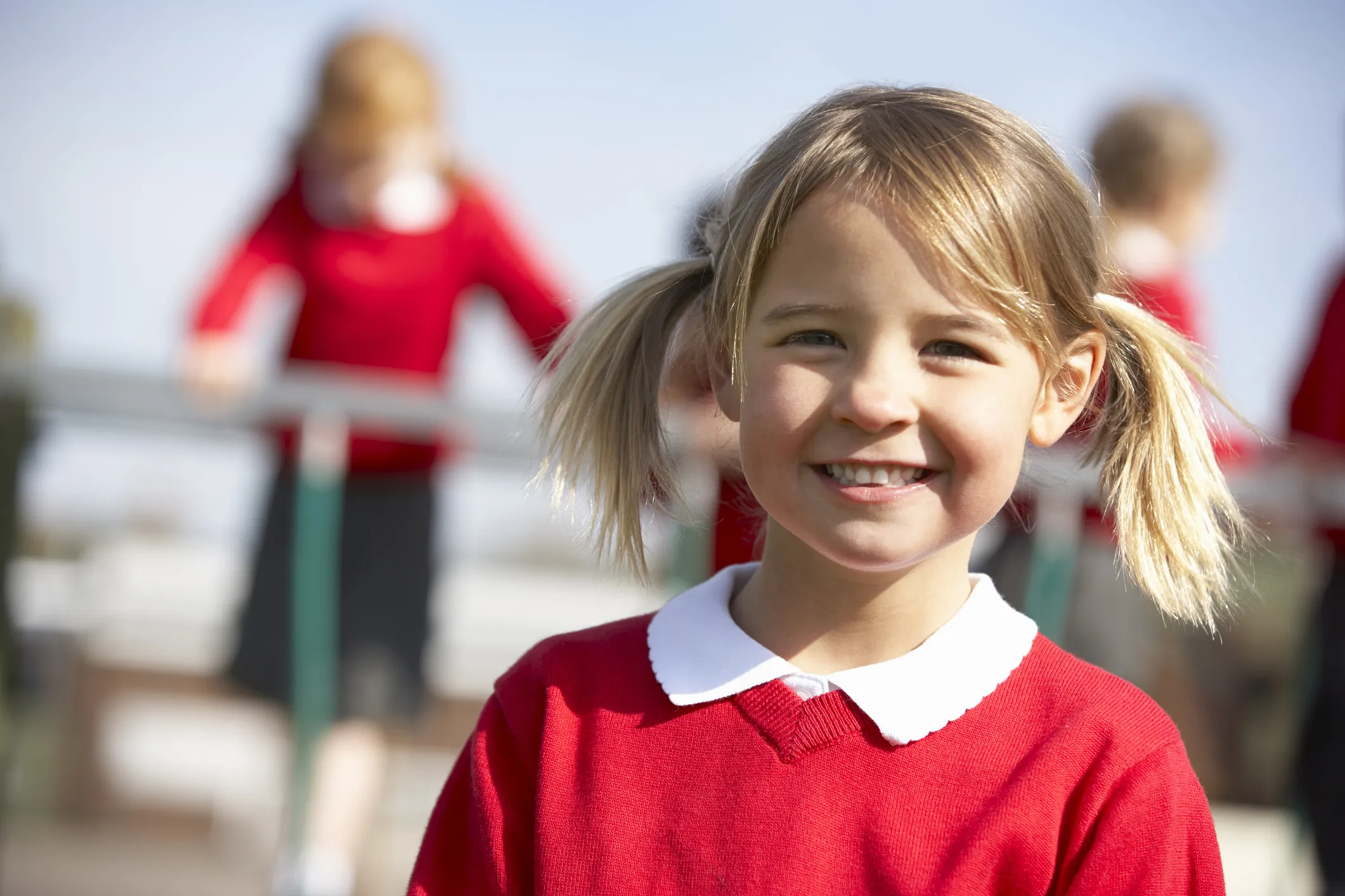 Portrait Of Female Elementary School Pupil In Playground Smiling To Camera
