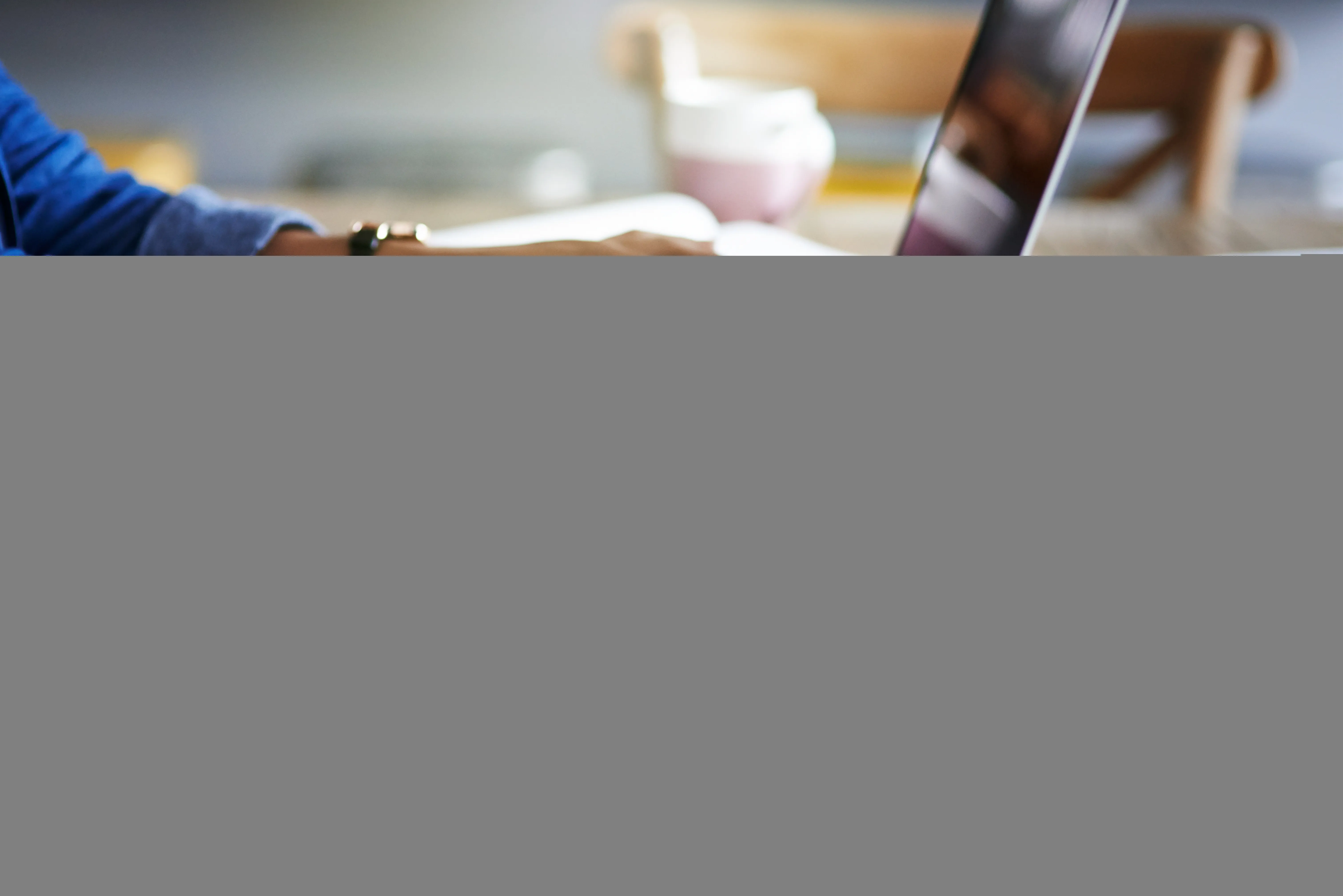 Cropped shot of a woman using a laptop while working from home