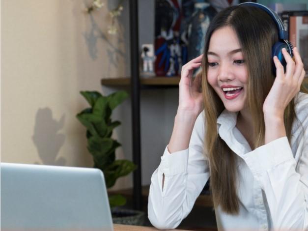 Girl using headset and laptop