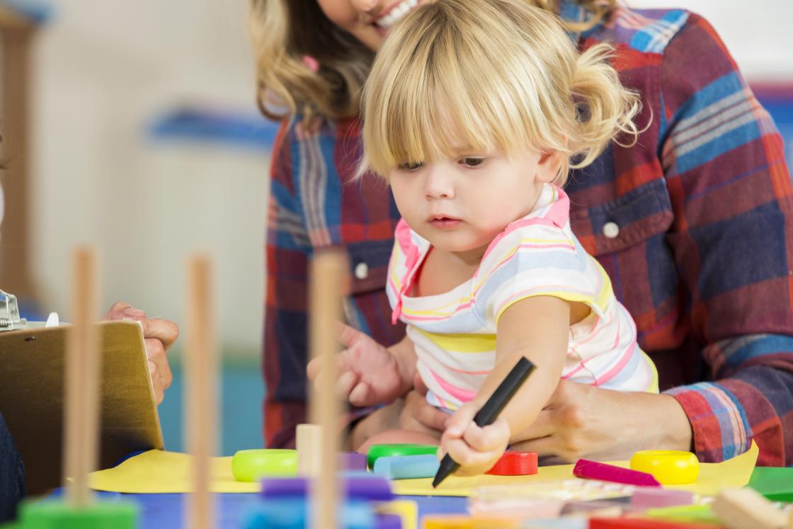 Young child playing with crayons