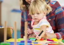 Young child playing with crayons