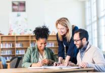 Teaching staff in a group reviewing notes